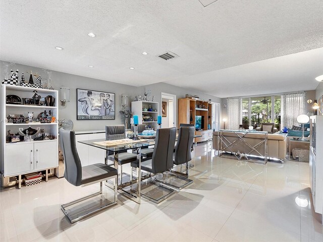 living room with expansive windows and a textured ceiling