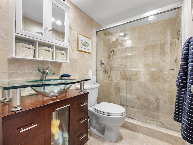 bathroom with backsplash, tile walls, vanity, an enclosed shower, and toilet