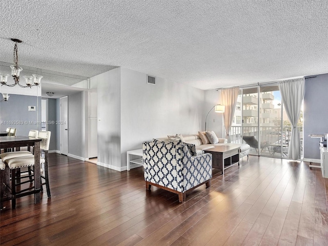 living room with dark hardwood / wood-style flooring and a textured ceiling