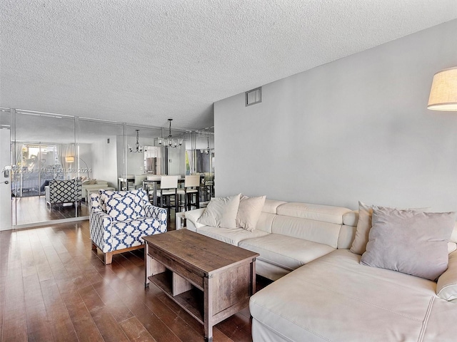 living room featuring a textured ceiling and dark hardwood / wood-style flooring