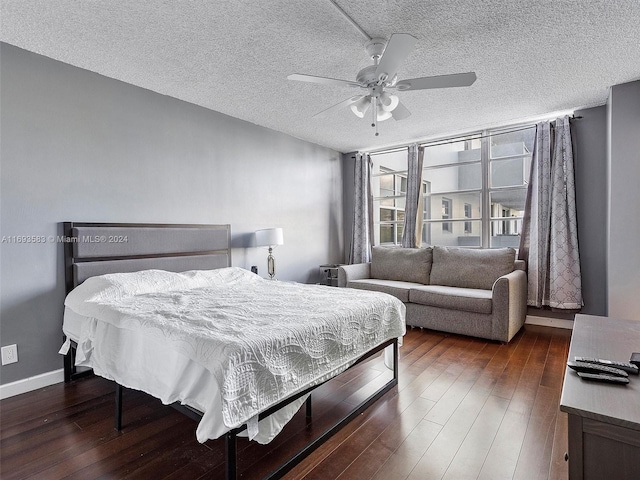 bedroom with a textured ceiling, dark hardwood / wood-style floors, and ceiling fan