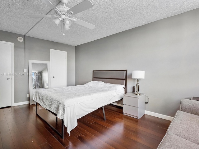 bedroom featuring a textured ceiling, dark hardwood / wood-style flooring, and ceiling fan