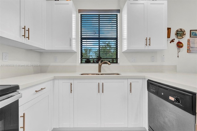 kitchen featuring appliances with stainless steel finishes, white cabinetry, and sink