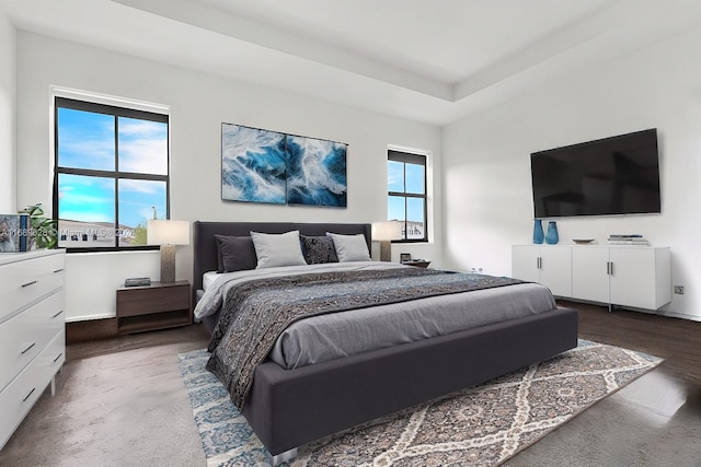 bedroom with dark hardwood / wood-style floors and multiple windows