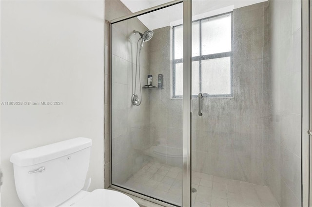 bathroom with an enclosed shower and toilet