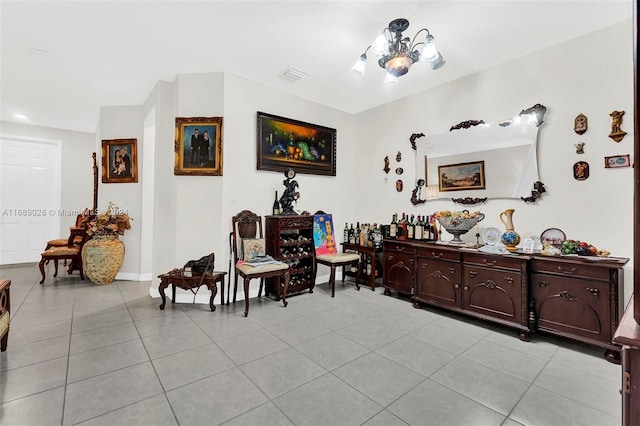 sitting room with light tile patterned floors and a notable chandelier