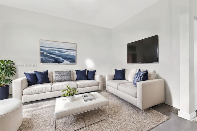 living room featuring tile patterned floors and lofted ceiling