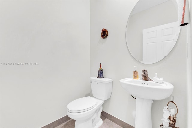 bathroom featuring tile patterned floors and toilet