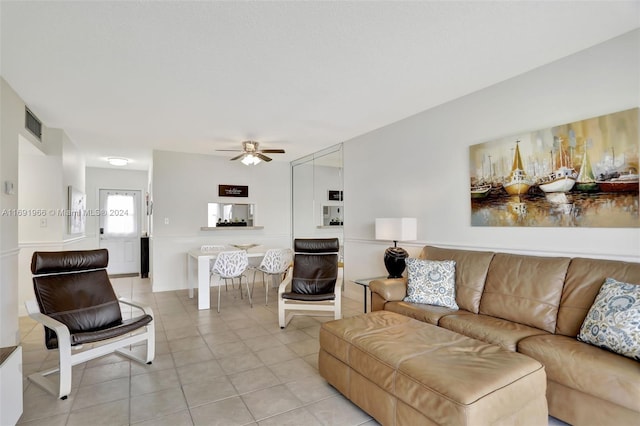 living room featuring ceiling fan and light tile patterned floors