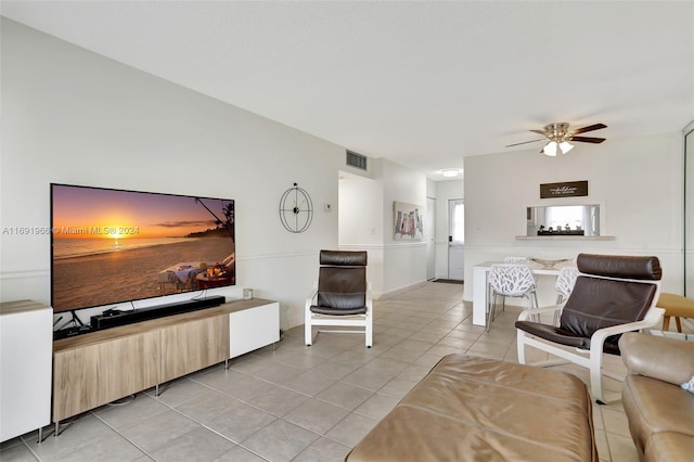 living room with ceiling fan and light tile patterned flooring