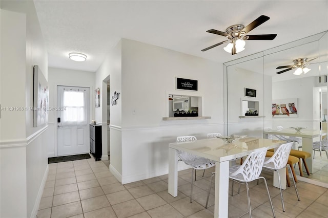 tiled dining space with ceiling fan