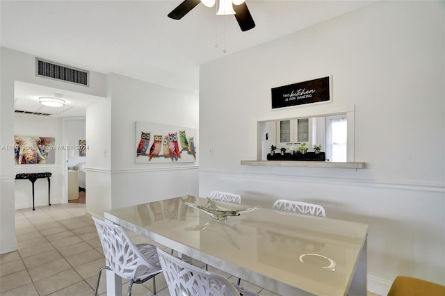 tiled dining space with ceiling fan