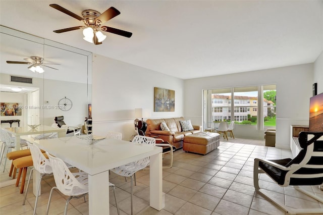 tiled dining room featuring ceiling fan