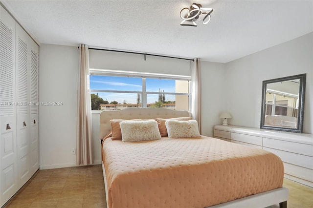 bedroom with a closet and a textured ceiling