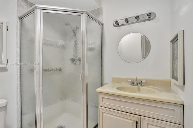 bathroom with vanity and a shower with shower door