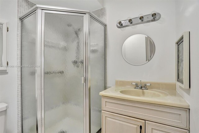 3501 NW 47th Ave Unit 504, Lauderdale Lakes, FL 33319 - bathroom featuring a stall shower, vanity, and toilet