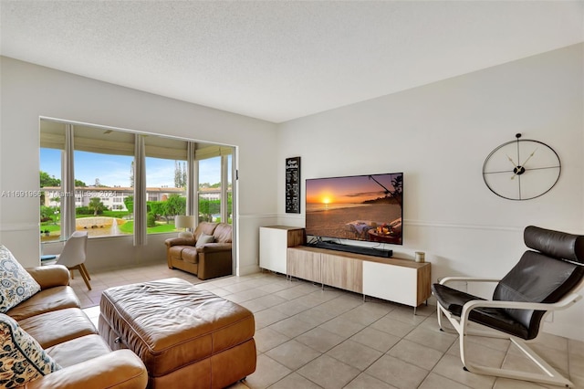 tiled living room featuring a textured ceiling