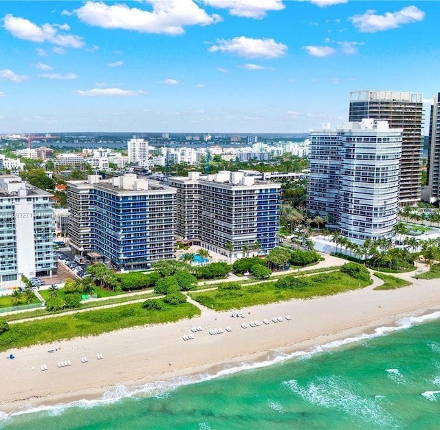 bird's eye view with a water view and a beach view