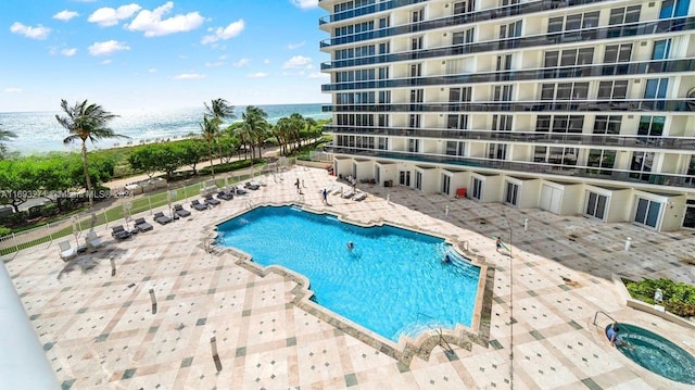 view of pool with a water view