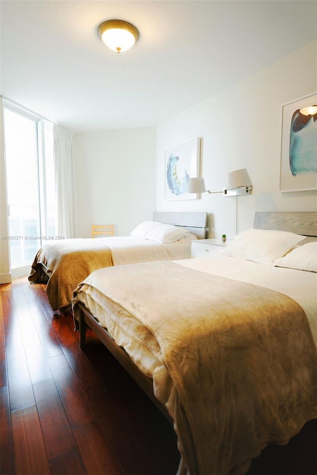 bedroom with dark wood-type flooring