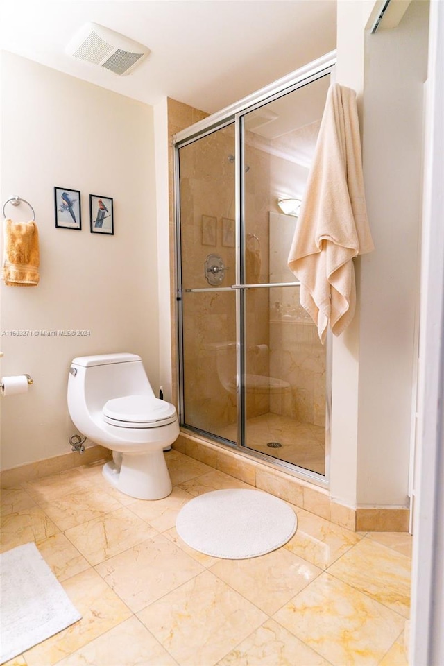 bathroom with toilet and walk in shower