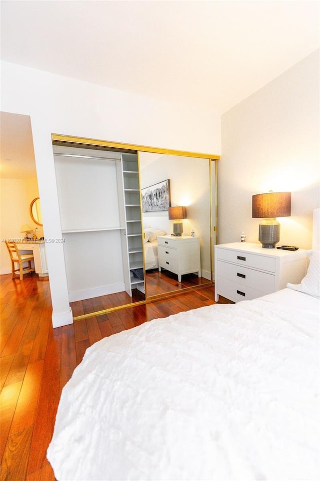 bedroom with dark wood-type flooring