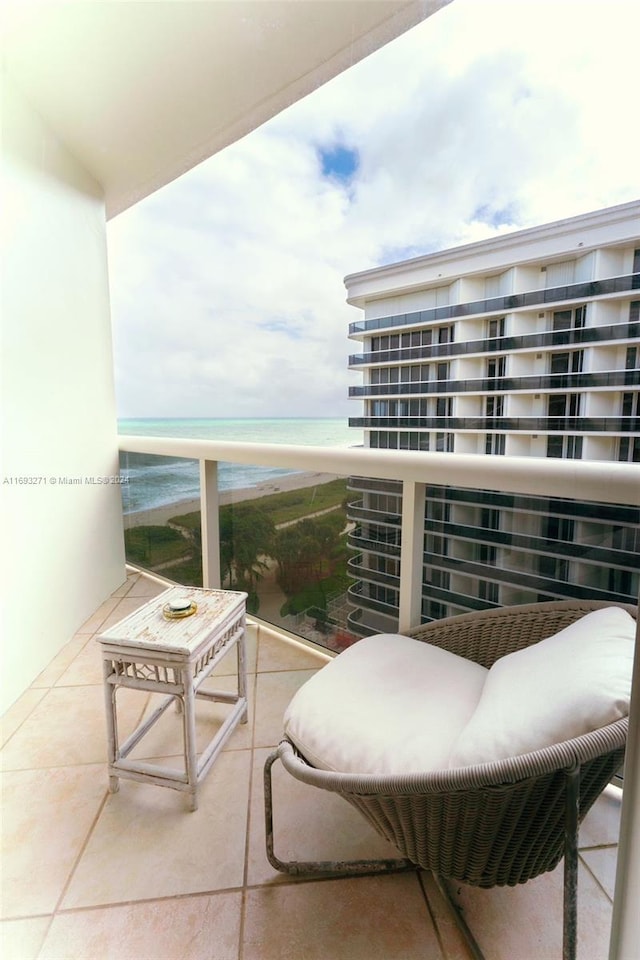 balcony featuring a water view and a view of the beach