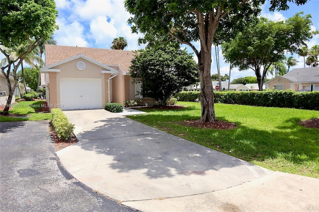 view of front of house with a garage and a front lawn