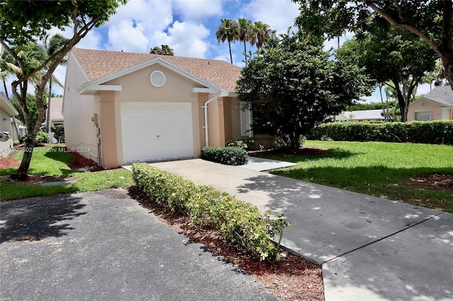 view of front of home featuring a garage and a front lawn