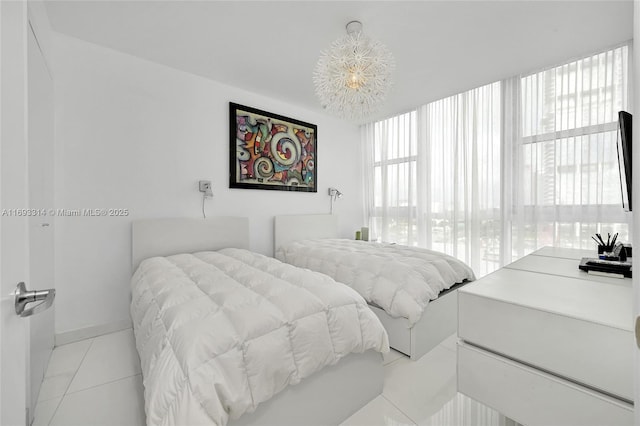 bedroom with a chandelier and light tile patterned floors