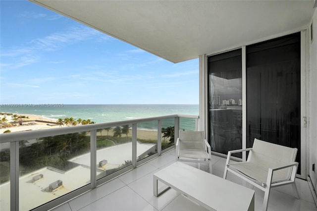 balcony with a water view and a beach view