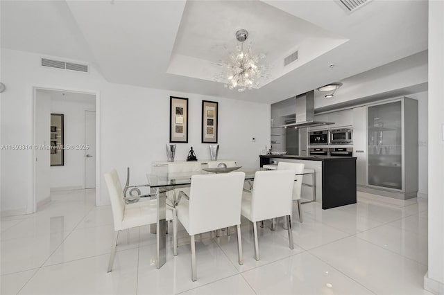 18201 Collins Ave Unit 1002, Sunny Isles Beach, FL 33160 - dining area featuring a chandelier, a tray ceiling, and light tile patterned floors