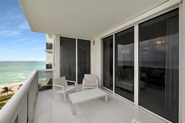 balcony with a water view and a beach view