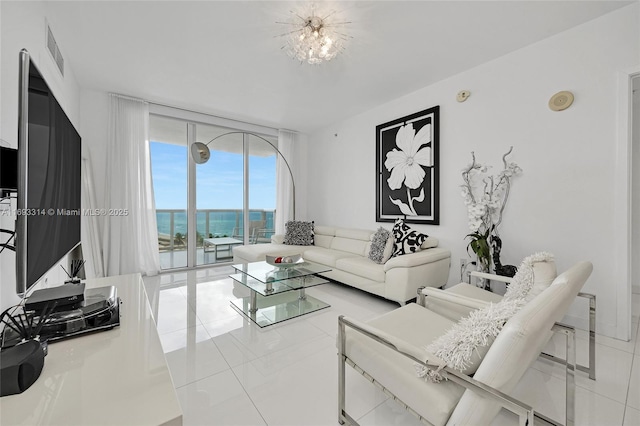 tiled living room featuring floor to ceiling windows