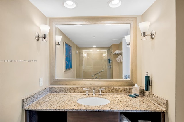 bathroom featuring vanity and a shower with shower door