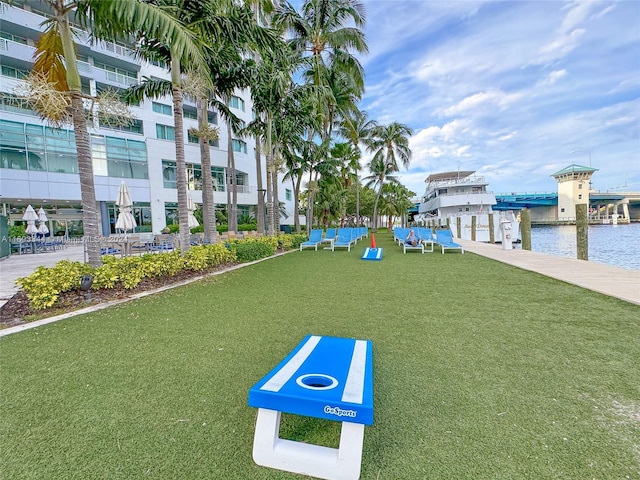 view of home's community featuring a water view and a lawn