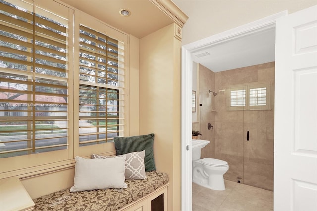 bathroom featuring toilet, tile patterned flooring, and walk in shower