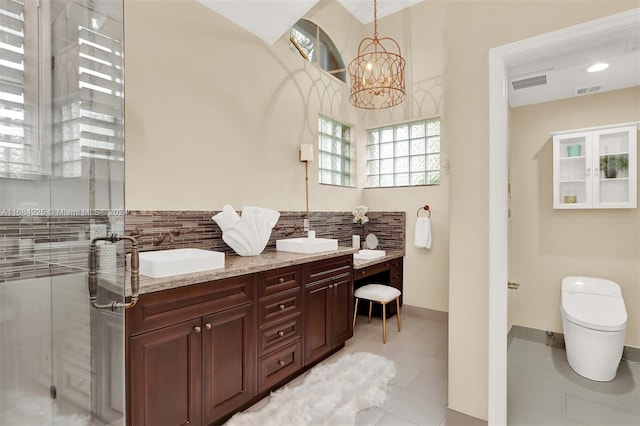 bathroom featuring tile patterned floors, vanity, a chandelier, toilet, and a shower with shower door