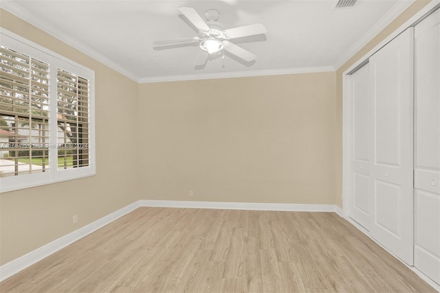 unfurnished bedroom featuring a closet, ceiling fan, light hardwood / wood-style flooring, and crown molding