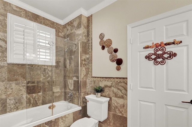 bathroom featuring toilet, ornamental molding, tile walls, and tiled shower / bath combo