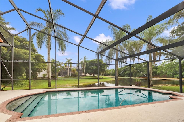 view of pool with a water view and glass enclosure