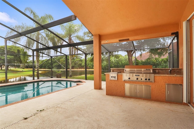 view of pool featuring an outdoor kitchen, a water view, glass enclosure, a patio area, and a grill