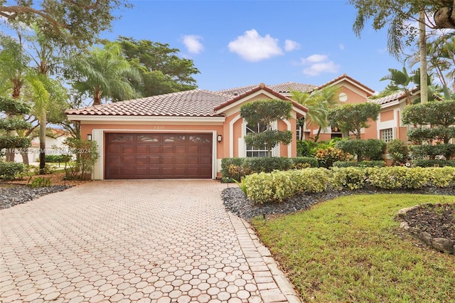 mediterranean / spanish house featuring a garage