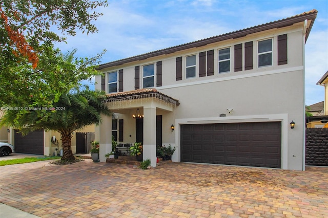 mediterranean / spanish-style home featuring a garage