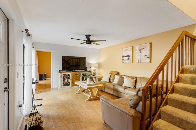 living room featuring light wood-type flooring and ceiling fan