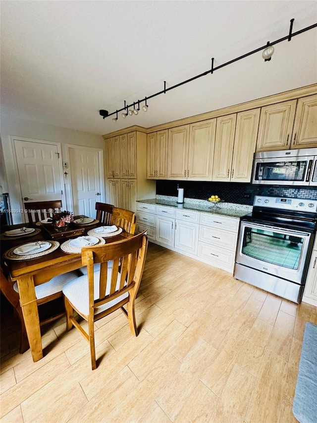 kitchen with decorative backsplash, light wood-type flooring, stainless steel appliances, and stone countertops