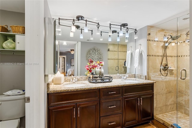 bathroom featuring vanity, toilet, and an enclosed shower