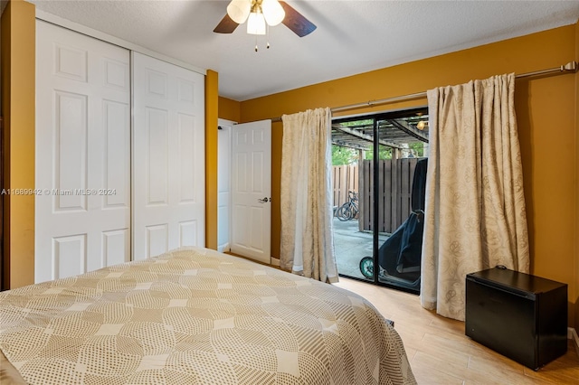 bedroom featuring access to exterior, a closet, a textured ceiling, ceiling fan, and light wood-type flooring