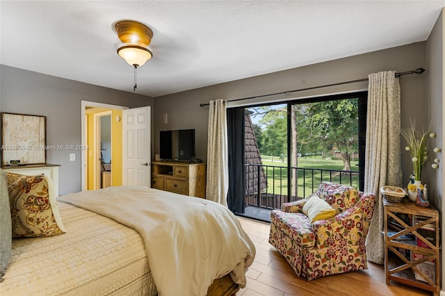 bedroom featuring hardwood / wood-style flooring, ceiling fan, and access to exterior