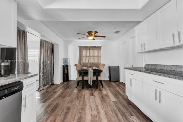 kitchen featuring white cabinets, dishwasher, dark wood-type flooring, and stone counters